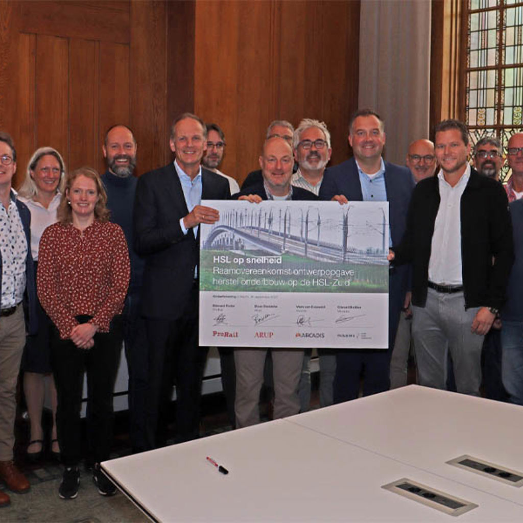 A group of people holding a sign.