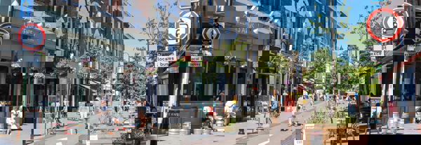 People walking down a street in the UK that has been revamped for pedestrians and cyclists