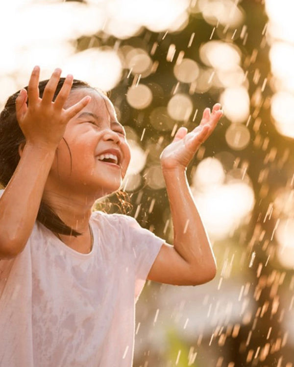 Child playing in water fountain - cities will need to rethink how they approach the sourcing of water