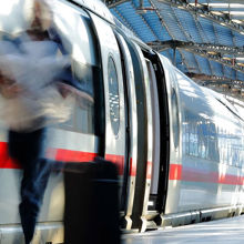 Train at a station with passengers on the platform