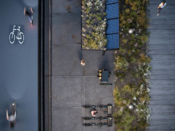 A person standing on a sidewalk.