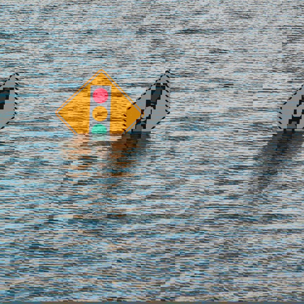 Road sign surrounded by water