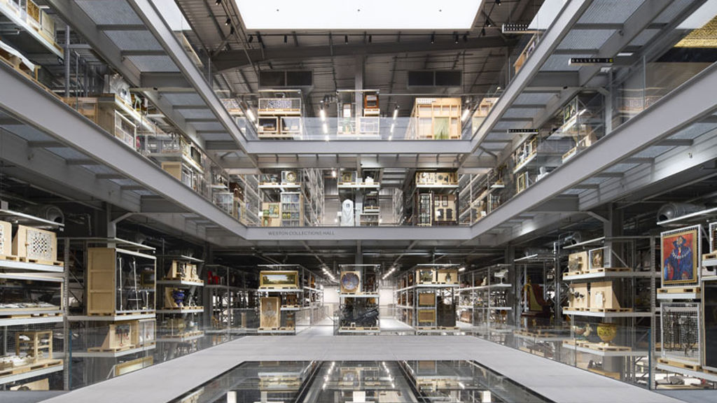 A large room with many shelves and a few escalators.
