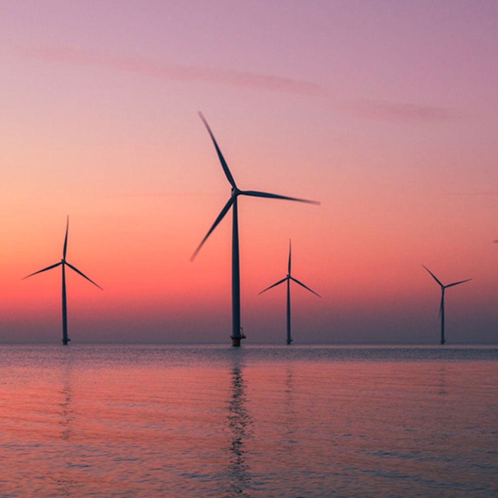 A group of wind turbines in a body of water.