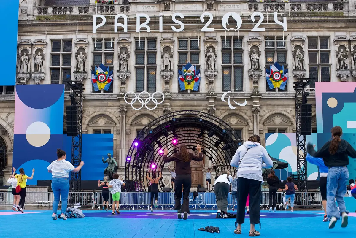 People using a fan zone at the Paris Olympics