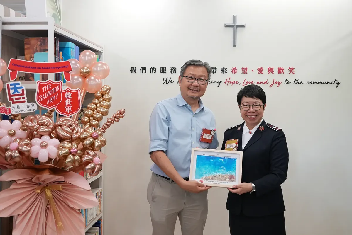 A person holding a plaque next to a person holding a plaque.