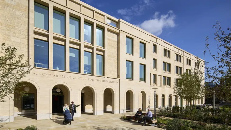 Entrance to the Schwarzman Centre at the University of Oxford, with people sitting outside.