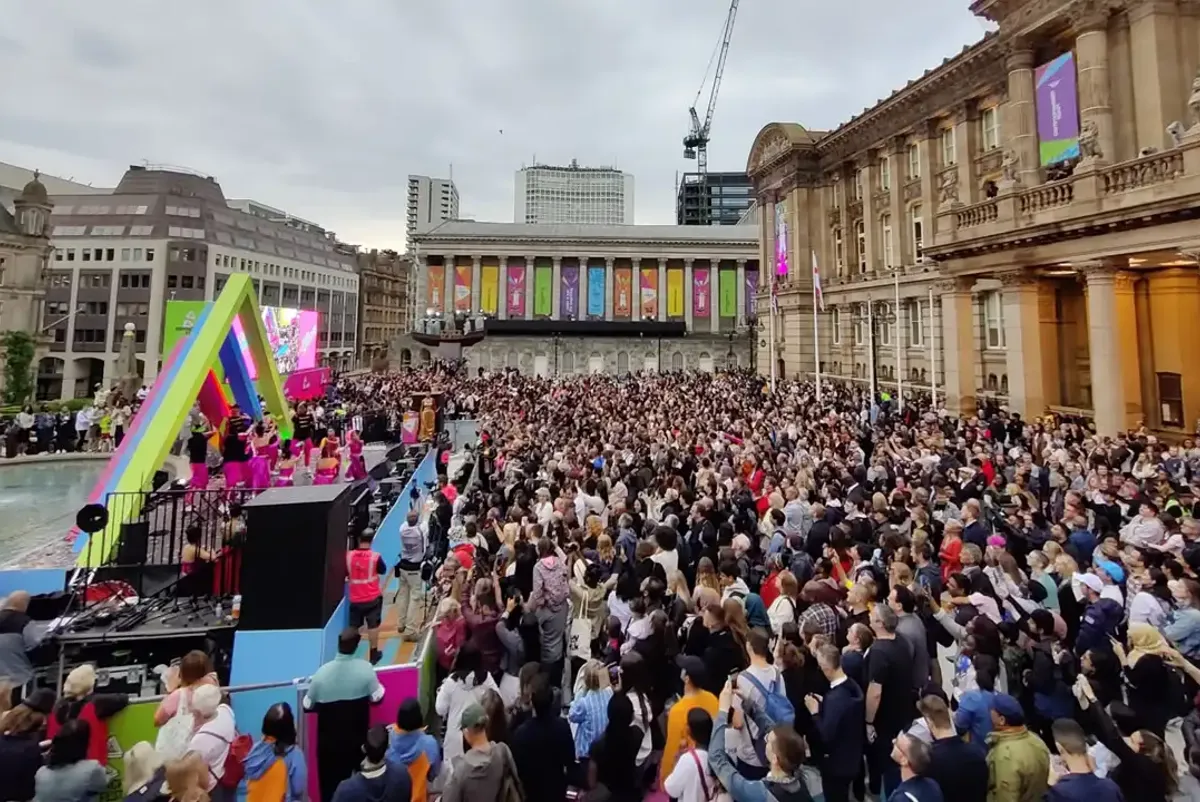 A crowd of people in a city.